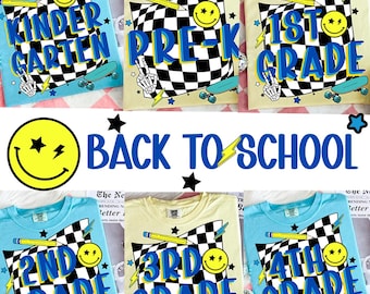May include: A collection of light blue and cream-colored t-shirts with grade level graphics. Each shirt features a checkered flag design, a smiley face, a pencil, and a skateboard. The text on the shirts reads "Kindergarten", "Pre-K", "1st Grade", "2nd Grade", "3rd Grade", and "4th Grade".