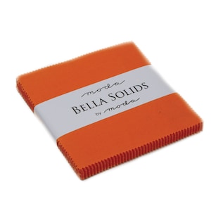 May include: A stack of orange fabric squares with a white label that reads "moda Bella Solids by moda".