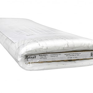 May include: A roll of white fusible non-woven fabric with a 2.5 inch grid printed on it. The label reads "Bosal Style #327C Origin USA 100% Polyester 2.5 Watercolor Grid Quilting/Craft Lightweight Fusible Non-woven with preprinted 2.5" Grid 48" Width 25 Yards".