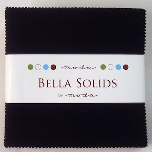 May include: A black fabric square with a white label that reads "moda Bella Solids by moda" with green, blue, and brown circles.