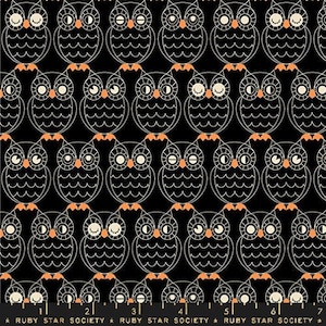 May include: Black fabric with a repeating pattern of white owls with orange eyes. The owls have a wavy pattern on their bodies and are outlined in white. The fabric has a repeating pattern of white stars and the text "RUBY STAR SOCIETY" in white.