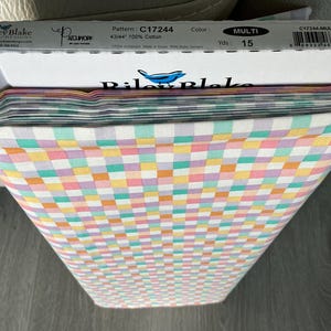 May include: A roll of Riley Blake Designs fabric with a multi-colored checkered pattern. The fabric is 43/44 inches wide and made of 100% cotton. The pattern is C17244, and the color is multi. The roll contains 15 yards of fabric.