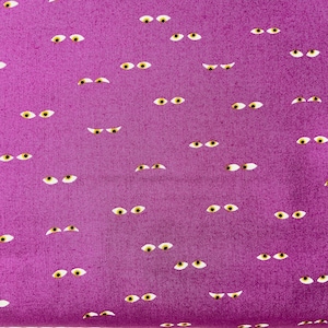 May include: Purple fabric with a repeating pattern of white eyes with yellow pupils.