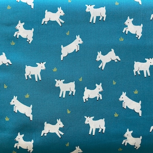 May include: A teal blue fabric with a repeating pattern of white goats. The goats are in various poses, some are standing, some are jumping, and some are running. The fabric is perfect for crafting projects, such as quilting, sewing, and scrapbooking.
