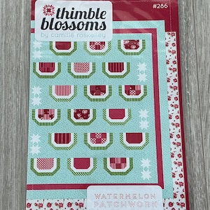 May include: A quilting pattern for a watermelon patchwork quilt. The pattern features a red, green, and white color scheme and includes a variety of watermelon-themed blocks. The pattern is titled "Watermelon Patchwork" and is a cheerful watermelon quilt.