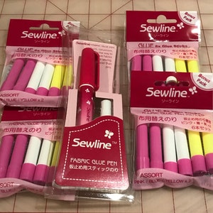 May include: Assortment of Sewline fabric glue sticks in pink, blue, and yellow. The packaging features the text "Sewline" and "Fabric Glue Pen" in Japanese and English. The glue sticks are labeled "Assort" and come in a pack of six.