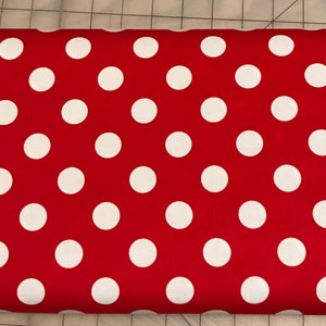 May include: Red fabric with white polka dots. The fabric has a smooth texture.