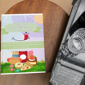 May include: A children's activity book titled "Yummy Foods Pack" with colorful illustrations of food items like a hot dog, pizza, and ice cream. The book is designed for ages 2-5 and includes activities like mazes and puzzles.