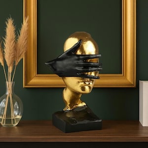 Abstract Gold Face Sculpture with Black Hand: Modern Art Decor