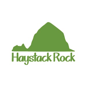 May include: A green silhouette of a mountain with the text "Haystack Rock" underneath.