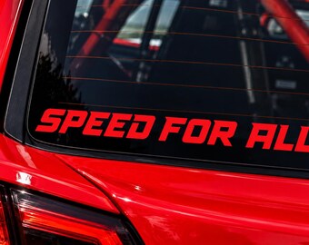 May include: A red vinyl decal applied to the rear window of a red vehicle. The decal features the text SPEED FOR ALL in a bold, slanted, sans-serif font. The lettering is solid red and contrasts against the dark glass of the car window.