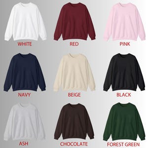 May include: A collection of crewneck sweatshirts in various colors, including white, red, pink, navy, beige, black, ash, chocolate, and forest green. Each sweatshirt has a simple, classic design with the color name displayed below.