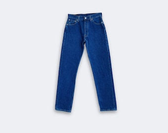 May include: A pair of blue denim jeans with a button and zip fly. The jeans have a straight leg cut and are made from a medium-weight denim. These jeans are a timeless wardrobe essential.