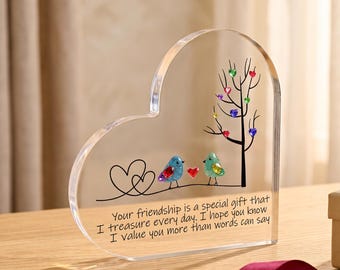 May include: A heart-shaped clear acrylic plaque featuring a printed design of two birds, a tree with colorful heart-shaped leaves, and the text: Your friendship is a special gift that I treasure every day. I hope you know I value you more than words can say.