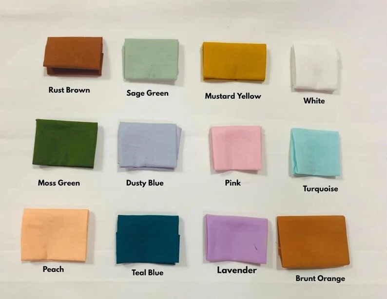 May include: A collection of folded fabric squares in various colors, including rust brown, sage green, mustard yellow, and white. Additional colors are moss green, dusty blue, pink, turquoise, peach, teal blue, lavender, and burnt orange. Each square has a color label.