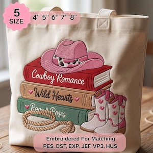 May include: A cream-colored canvas tote bag featuring an embroidered design of a pink cowboy hat resting on a stack of three books labeled Cowboy Romance, Wild Hearts, and Ropes & Roses, with white cowboy boots and a rope, available in 5 sizes: 4, 5, 6, 7, 8 inches.