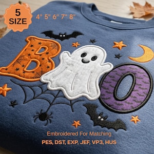 May include: A blue sweatshirt featuring an embroidered design with the text "BOO" where the "B" is orange with spiderwebs, a white ghost replaces the "O", and the final "O" is purple with bats. Includes black bats, orange stars, and spiders.