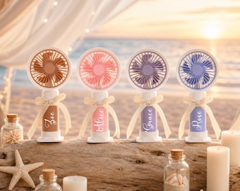 May include: Four portable handheld fans with white circular frames and colored blades in tan, pink, purple, and blue. Each fan handle features a matching color, a white name label reading Zoe, Alice, Grace, or Rose, and a tied beige ribbon.