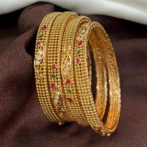 May include: A set of three ceramic mugs with a speckled, matte finish. The mugs are in shades of cream, light gray, and dark gray. Each mug has a simple, minimalist design, perfect for coffee or tea.