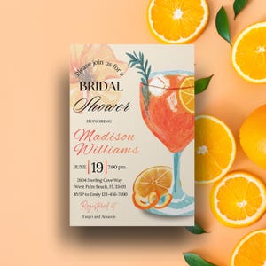 May include: Bridal shower invitation featuring a watercolor illustration of a cocktail with orange slices. The invitation includes the text "Please join us for a Bridal Shower honoring Madison Williams" and event details. The design is set against an orange background with orange slices.