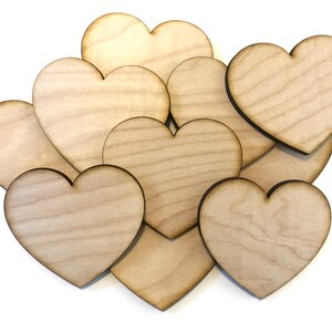 May include: A pile of eight unfinished wooden heart shapes, perfect for crafting and DIY projects.