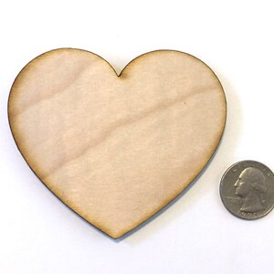May include: A plain, unfinished wooden heart shape, approximately the size of a US quarter.
