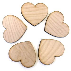 May include: Five unfinished wooden heart shapes, each with a natural wood grain pattern.