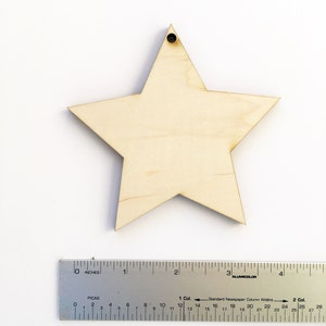 Pu&ograve; includere: Una stella di legno marrone chiaro con un foro nella parte superiore. La stella &egrave; larga circa 10 cm.
