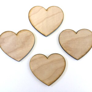 May include: Four unfinished wooden heart shapes, each with a natural wood grain.