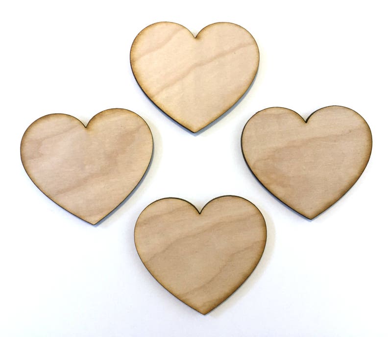 May include: Four unfinished wooden heart shapes, each with a natural wood grain.