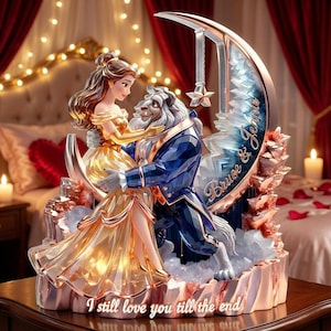 May include: A decorative figurine depicting Belle and the Beast embracing, set against a crescent moon and a backdrop of a bedroom. The figurine features gold and blue tones, with the text "Bruce & Jennie" and "I still love you till the end".