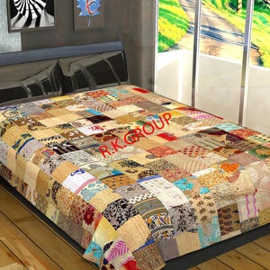 May include: A patchwork quilt in various colours and patterns, including beige, brown, red, and blue. The quilt is on a bed, with the text "R.K. GROUP" visible. The quilt is a decorative bed covering.