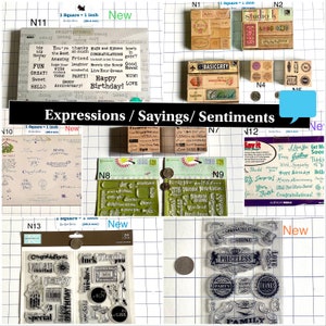 May include: Assortment of clear and wood mounted rubber stamps with various sayings and sentiments. The stamps are arranged on a gridded surface. The stamps are 1 inch square and feature phrases like "Happy Birthday", "Congratulations", "Love", and "You're the Best".