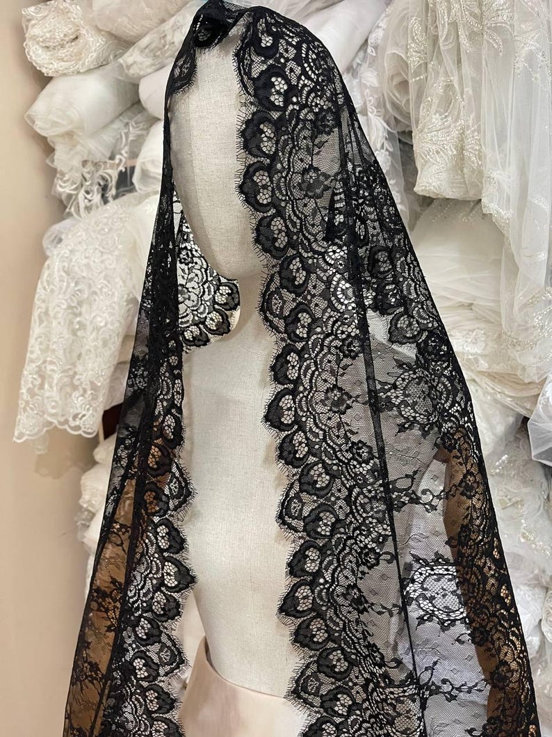 gothic spiderweb lace trim by the yard, black lace fabric for halloween costumes, decorative lace for gothic dresses and veils, lace material for shawls and capes, halloween spiderweb lace for diy sewing projects, black lace yardage for cosplay and gothic outfits, intricate lace for skirts, masks, and accessories, fabric for halloween crafts and themed apparel, gothic lace for handmade decorations, black spiderweb lace for costume making and sewing supplies
