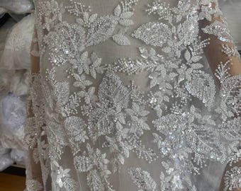Ivory floral embroidered beaded lace fabric with sequins on soft tulle for wedding dresses, veils, capes and luxury bridal gowns