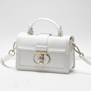 May include: A white, rectangular handbag with a top handle and a detachable shoulder strap. The bag features a textured, crocodile-like pattern and a gold-colored clasp. The bag is set against a white background.