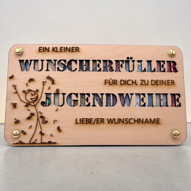 May include: A light-colored wooden plaque with cut-out lettering and a stick figure celebrating with money. The text includes "EIN KLEINER WUNSCHERF&Uuml;LLER" and "JUGENDWEIHE". Gold-colored screws secure the corners.