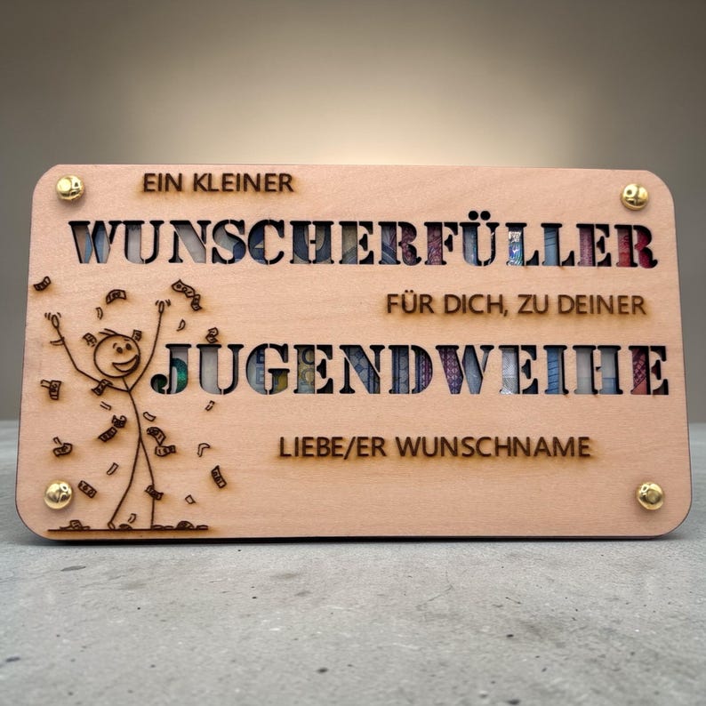 May include: A wooden plaque with cut-out lettering and a stick figure celebrating with money. The text reads "EIN KLEINER WUNSCHERF&Uuml;LLER F&Uuml;R DICH, ZU DEINER JUGENDWEIHE LIEBE/ER WUNSCHNAME". Gold-colored rivets secure the corners.