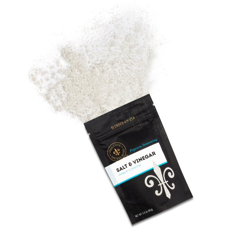 Salt and vinegar seasoning pouch laying with seasoning spilling out of top. Dell Cove Spices