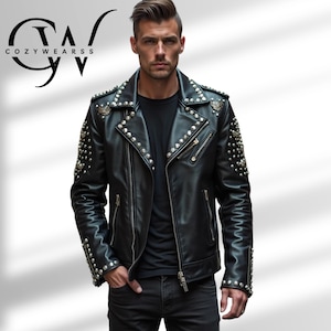 May include: Black leather jacket with silver studs and zippers. The jacket has a classic biker style with a notched collar and shoulder epaulets. The brand name "COZYWEARSS" is visible in the upper left corner.