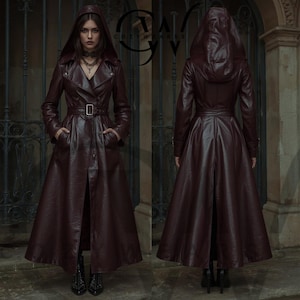 May include: A long, hooded burgundy leather coat with a belted waist and button closure. The coat features a wide skirt and is shown from the front and back. The coat has long sleeves and pockets. The brand name "COZYWEARS" is visible in the upper right corner.