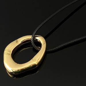 Gold Abstract Pendant Necklace, Sculptural Open Charm on Black Cord, Modern Minimalist Fashion Jewelry for Women