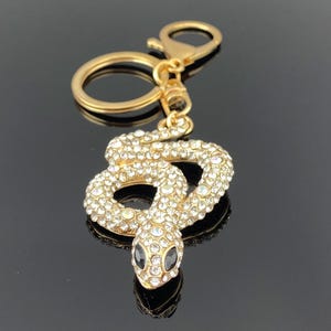 Llavero de serpiente dorada: dije para bolso con forma de serpiente y diamantes de imitación iridiscentes