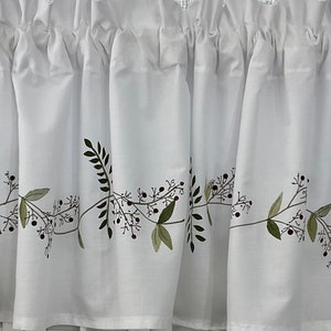 May include: White valance with a green and brown embroidered floral design. The design features a vine with leaves and berries.