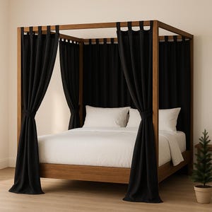 May include: A wooden four-poster bed with black curtains and white bedding. The bed frame is a warm brown colour, and the curtains are tied back on the posts. A small potted evergreen tree sits beside the bed.