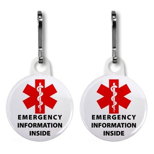 Puede incluir: Dos tiradores de cremallera blancos con un s&iacute;mbolo de estrella de la vida roja y el texto "Informaci&oacute;n de emergencia en el interior".
