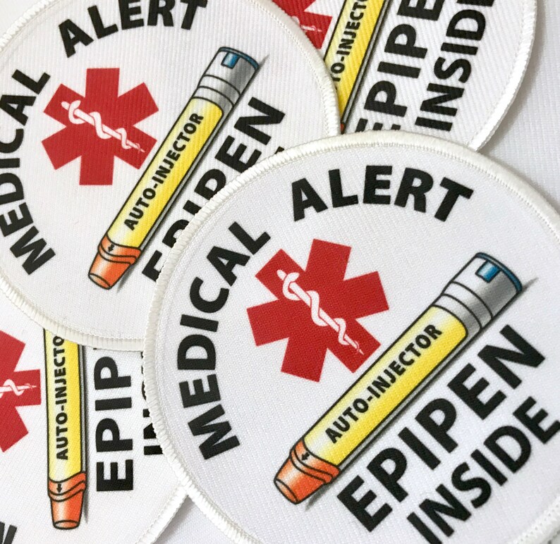 May include: Four white round medical alert patches with red star of life symbols and a yellow auto-injector with the text "AUTO-INJECTOR EPIPEN INSIDE" printed on them.