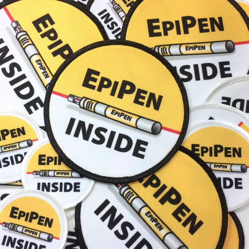 May include: A collection of yellow and white round patches with black text and a red line. The text on the patches reads "EPIPEN INSIDE".