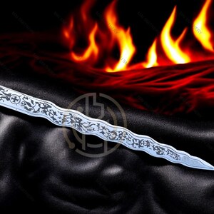 May include: A silver dagger with an ornate, etched design lies on a black surface, with a fiery background of red and orange flames. The dagger's blade features intricate patterns and a cross symbol.