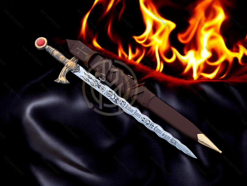 May include: An ornate sword with a silver blade and gold accents, featuring engraved text and a red gem on the pommel. The sword rests beside a brown leather sheath, with a fiery background.